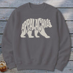 Dark gray crewneck sweatshirt featuring a cream-colored graphic of a walking bear filled with the text Appalachia.