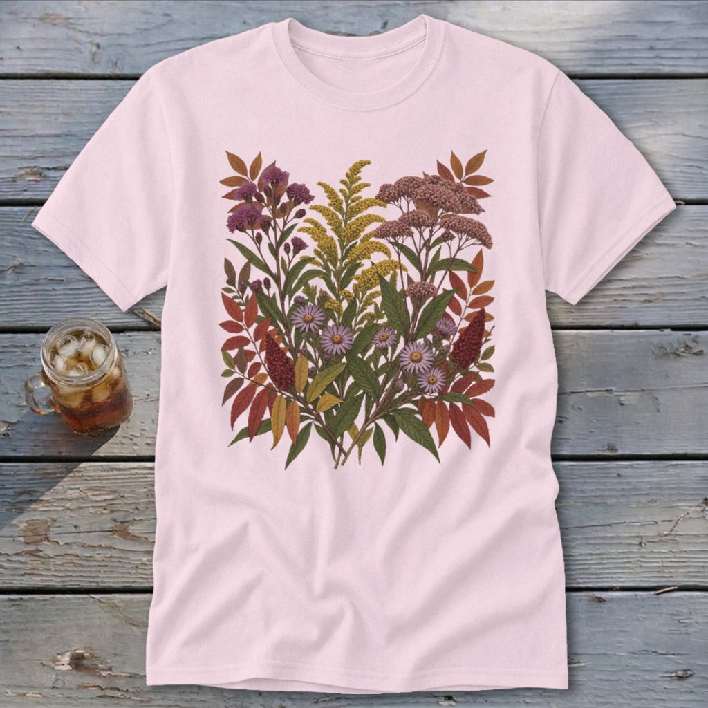 Pink t-shirt with a botanical illustration of wildflowers and fall leaves.
