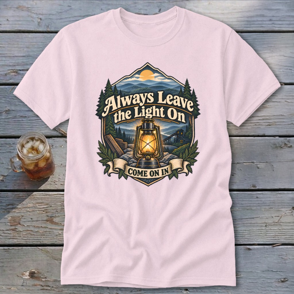 Pink t-shirt with "Always Leave the Light On Come On In" graphic and a lantern.