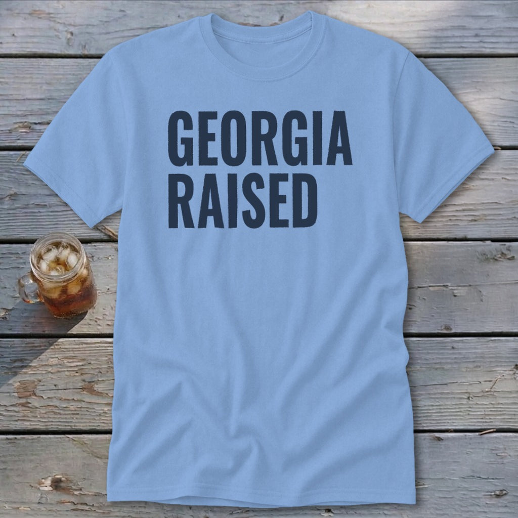 Light blue t-shirt with "GEORGIA RAISED" in navy text.
