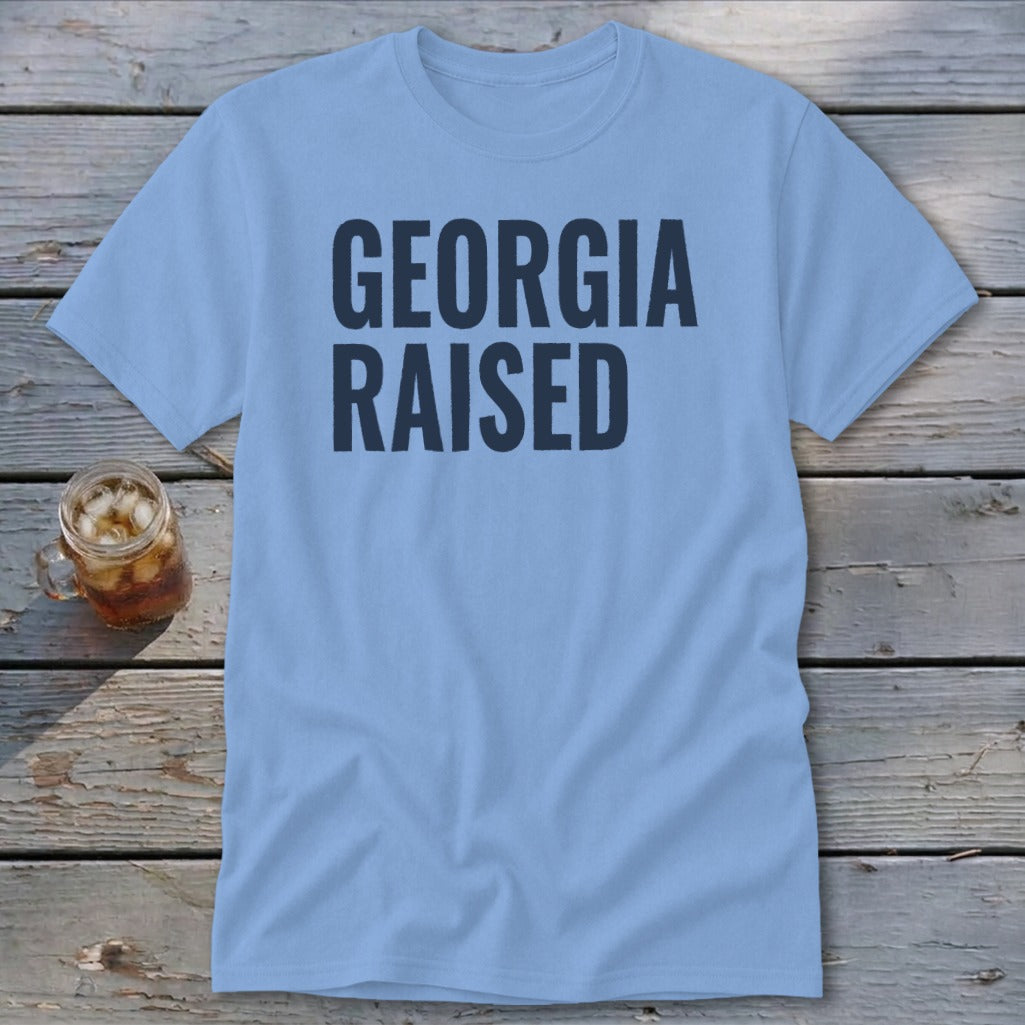 Light blue t-shirt with "GEORGIA RAISED" in navy text.