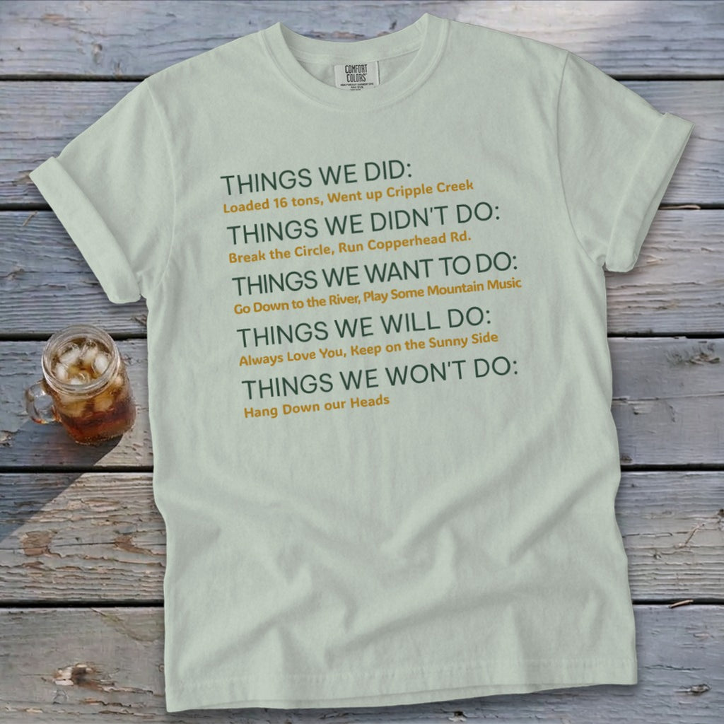 Light green t-shirt with green and orange text listing things done, not done, want to do, will do, won't do.