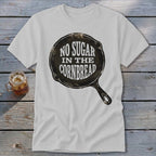 White t-shirt with graphic of a cast iron skillet saying "No Sugar In The Cornbread".