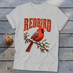 Light gray t-shirt featuring a graphic of a red cardinal on a snowy branch with redbird text.