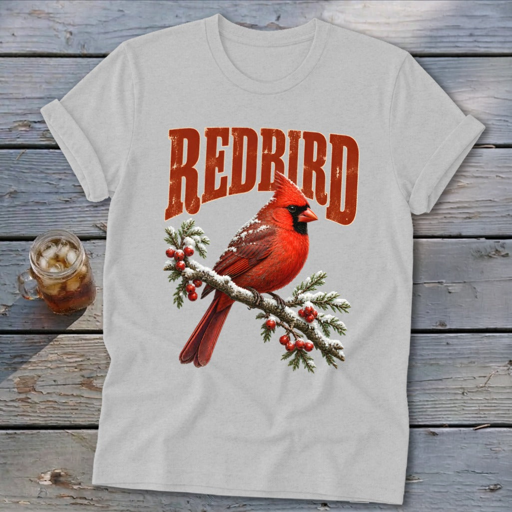 Light gray t-shirt featuring a graphic of a red cardinal on a snowy branch with redbird text.