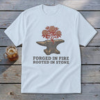 White t-shirt with anvil graphic, flowering plant, and text "FORGED IN FIRE ROOTED IN STONE".
