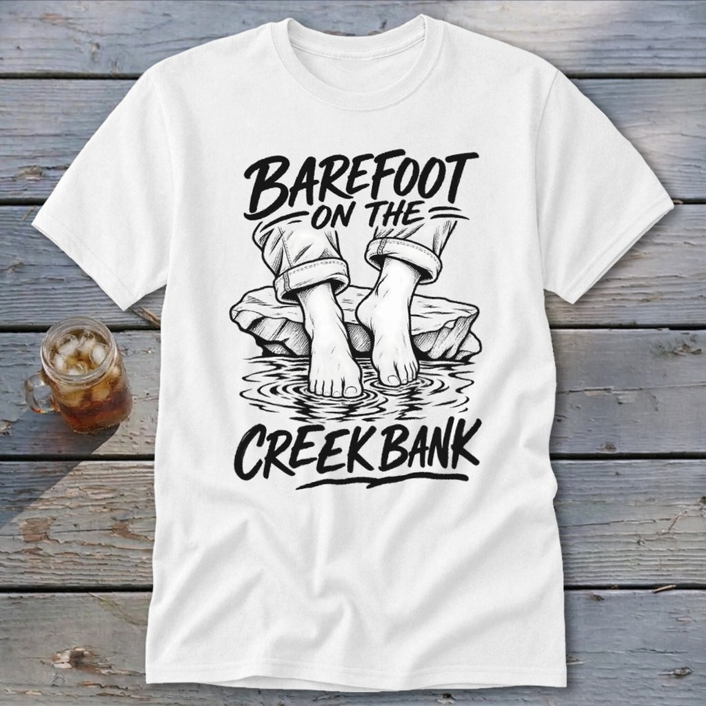 White t-shirt with "BAREFOOT ON THE CREEK BANK" text and drawing of bare feet.