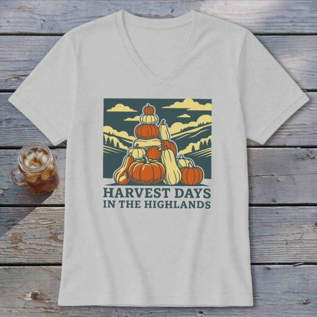 Light gray V-neck t-shirt featuring a graphic of stacked pumpkins and the text "Harvest Days in the Highlands."