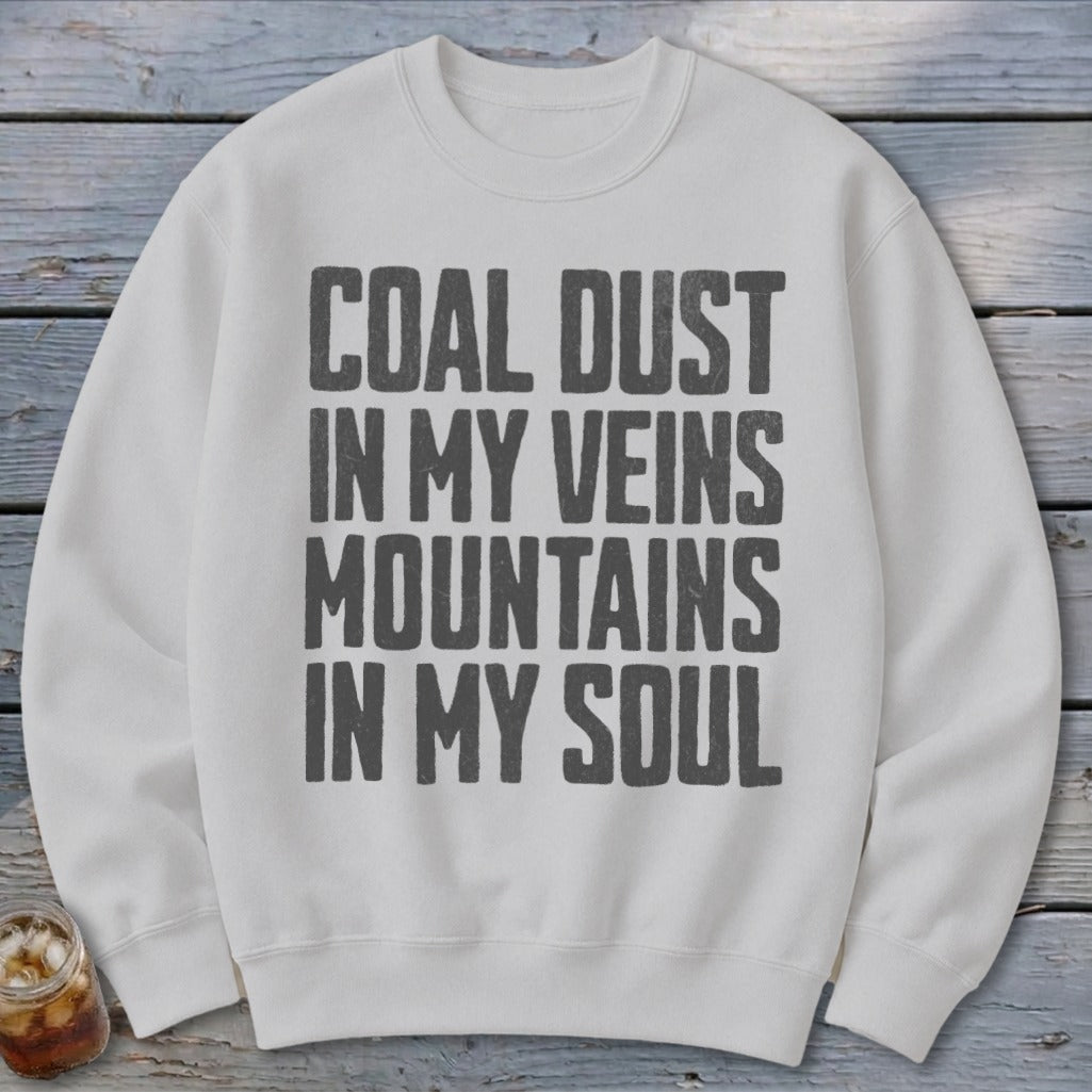 A light gray crewneck sweatshirt featuring the text COAL DUST IN MY VEINS MOUNTAINS IN MY SOUL.
