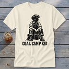 Cream t-shirt with black graphic of a seated boy and the text "COAL CAMP KID".