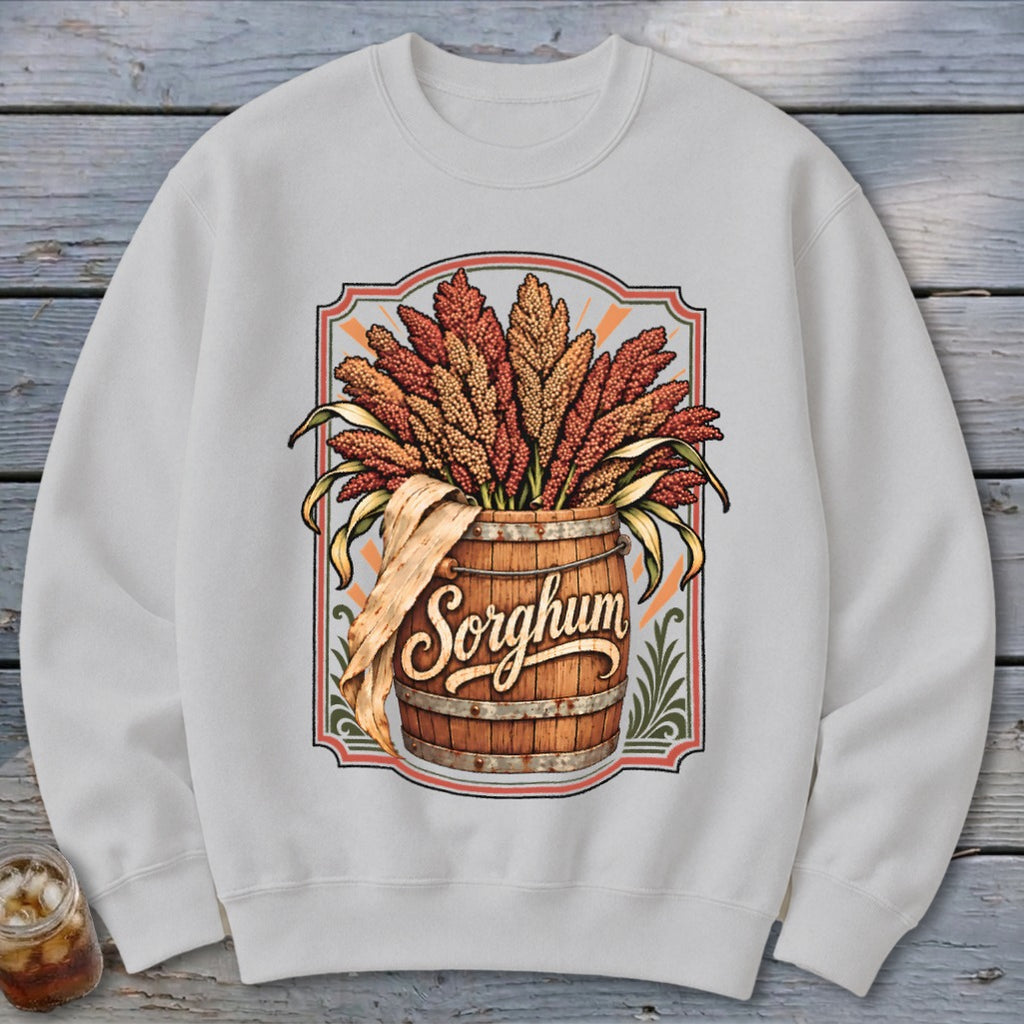 Wooden barrel overflowing with sorghum stalks with the word "Sorghum" on the barrel.