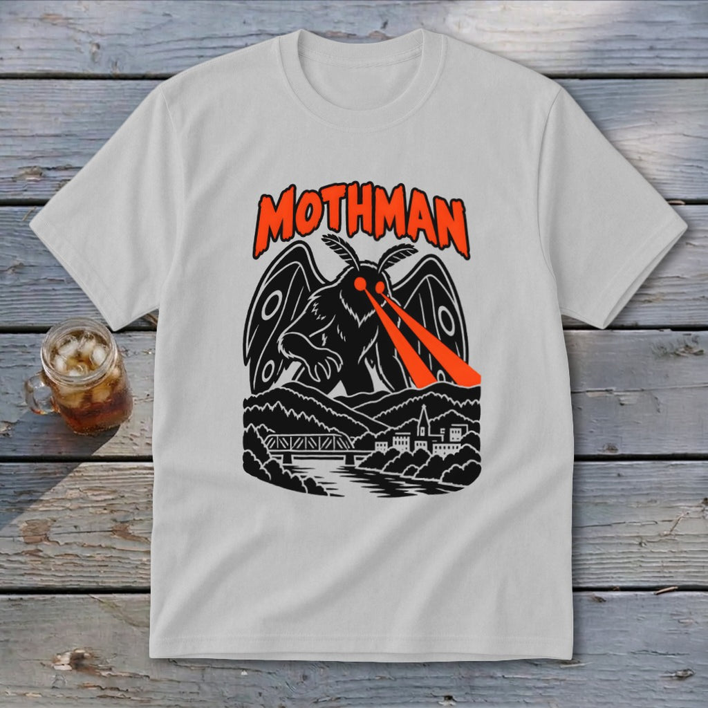Mothman graphic on a white t-shirt with red eyes shooting lasers over a town.