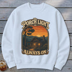White sweatshirt with "The Porch Light is Always On" text and cabin scene.