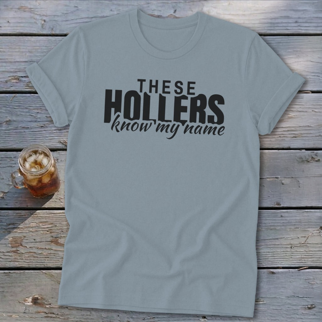 Light blue t-shirt with black text: "THESE HOLLERS know my name"
