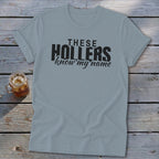 Light blue t-shirt with black text: "THESE HOLLERS know my name"