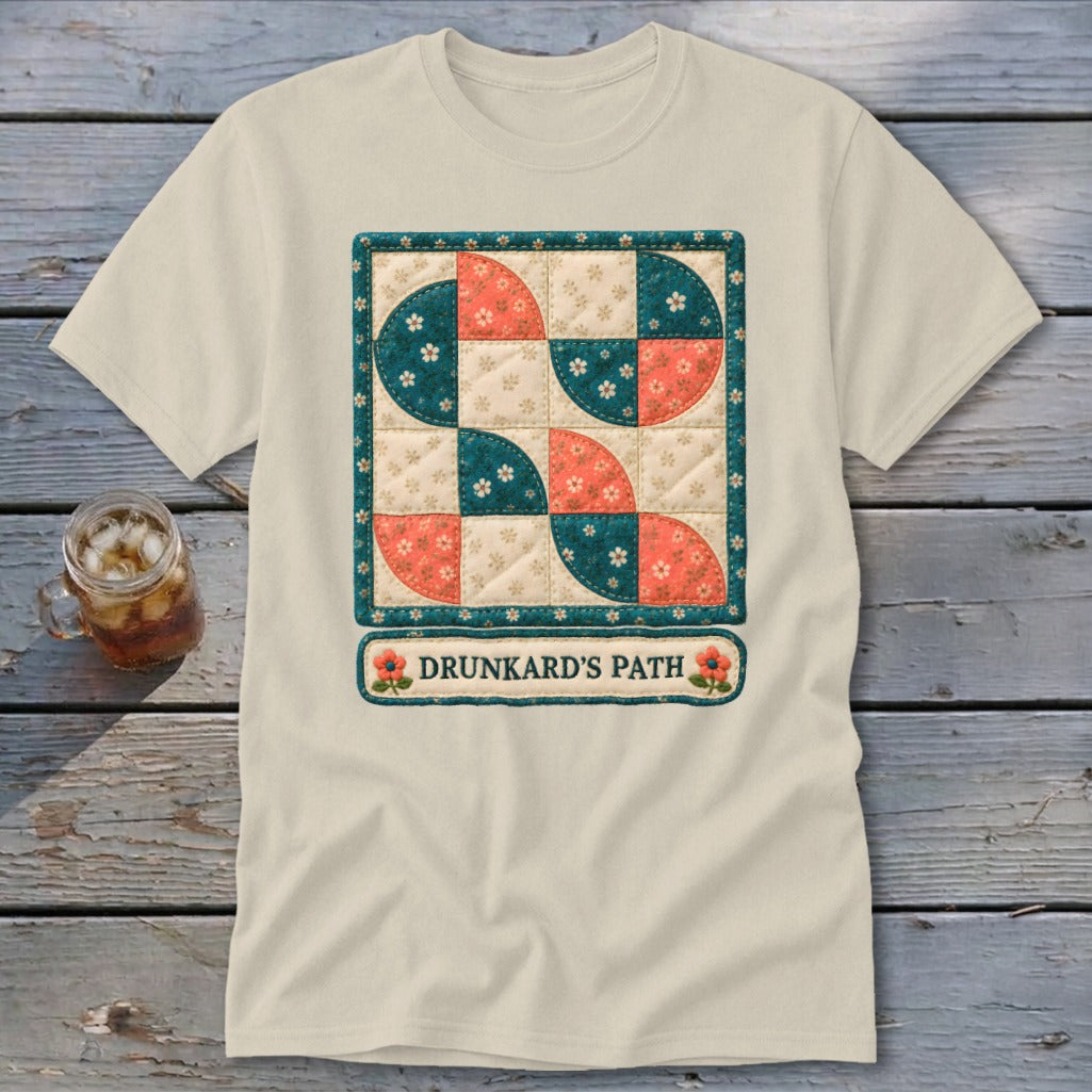 Cream t-shirt with a "Drunkard's Path" quilt design and floral accents.