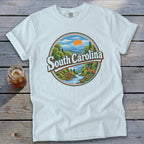 White t-shirt with circular graphic of South Carolina landscape with deer.