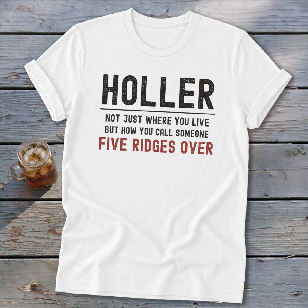 White t-shirt with "HOLER NOT JUST WHERE YOU LIVE BUT HOW YOU CALL SOMEONE FIVE RIDGES OVER" text.