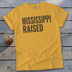 Yellow t-shirt with "MISSISSIPPI RAISED" printed in dark gray text.