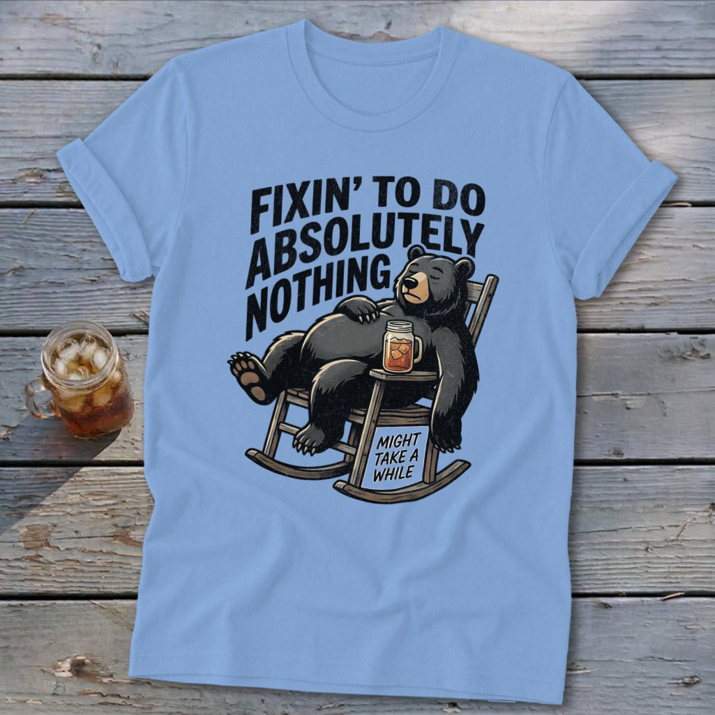 Light blue t-shirt featuring a cartoon bear relaxing in a rocking chair with text.