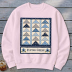Pink sweatshirt with a blue and gray flying geese quilt design and "Flying Geese" text.