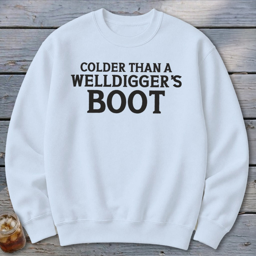 White sweatshirt with black text: "Colder Than a Welldigger's Boot."