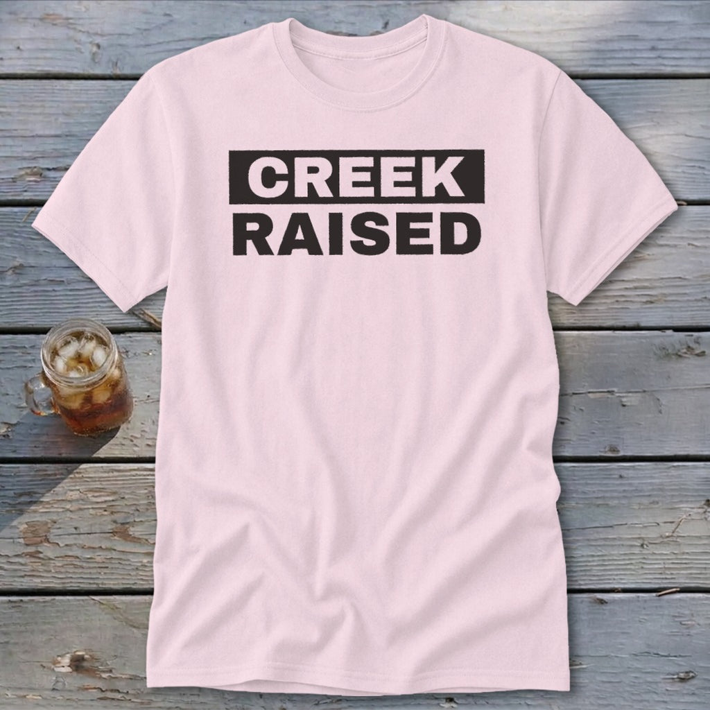 Light pink t-shirt with "CREEK RAISED" in black text.