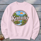 Pink sweatshirt with circular Kentucky nature graphic featuring deer and river.