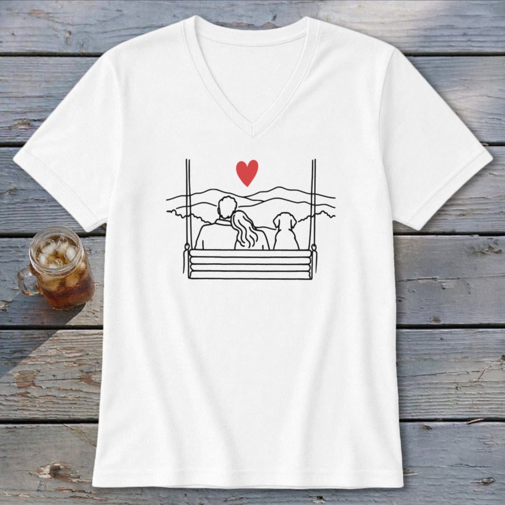 White t-shirt with a line drawing of a couple and dog on a swing with a red heart above.