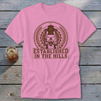 Pink t-shirt with brown lantern graphic and "ESTABLISHED IN THE HILLS" text.
