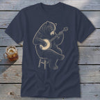 Bear playing a banjo while sitting on a stool.