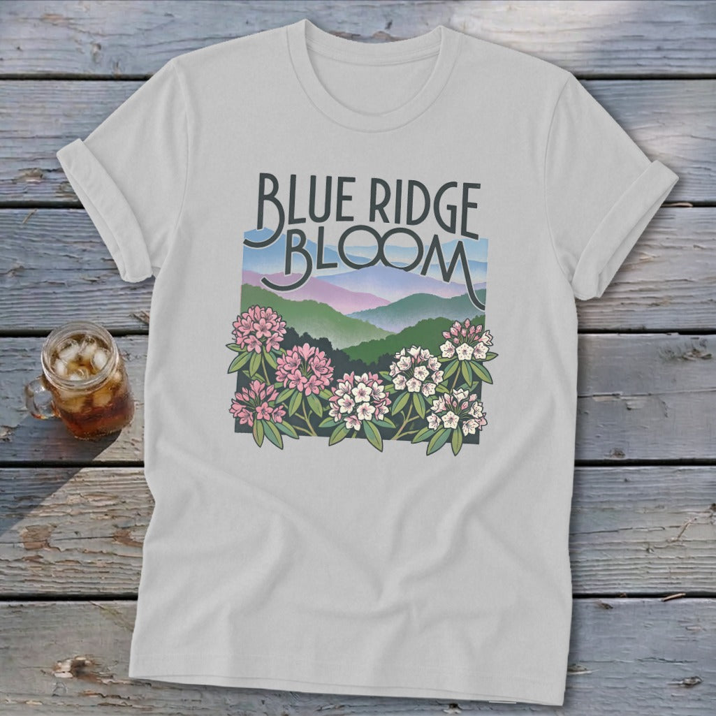 White t-shirt with "Blue Ridge Bloom" text and mountain landscape with flowers.
