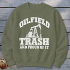 Olive green sweatshirt with white text and oil rig graphic: "OILFIELD TRASH AND PROUD OF IT"