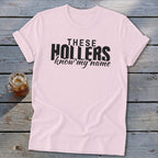 Pink t-shirt with black text "THESE HOLLERS know my name".