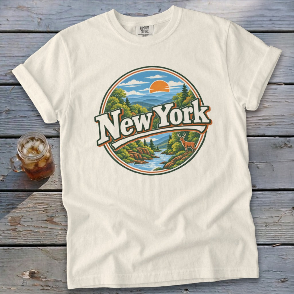 Cream t-shirt with circular graphic of New York landscape and deer.