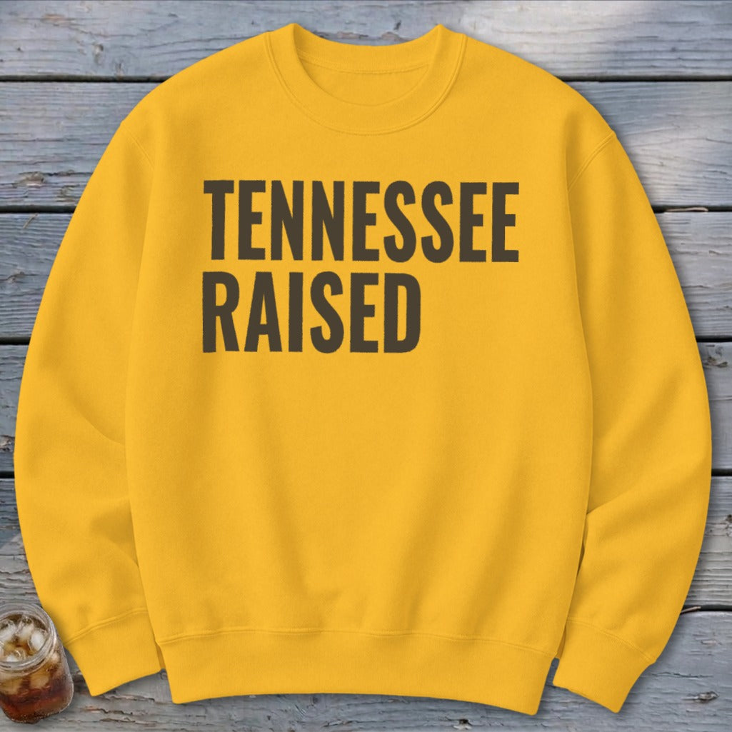 Yellow crewneck sweatshirt with "TENNESSEE RAISED" in dark gray text.