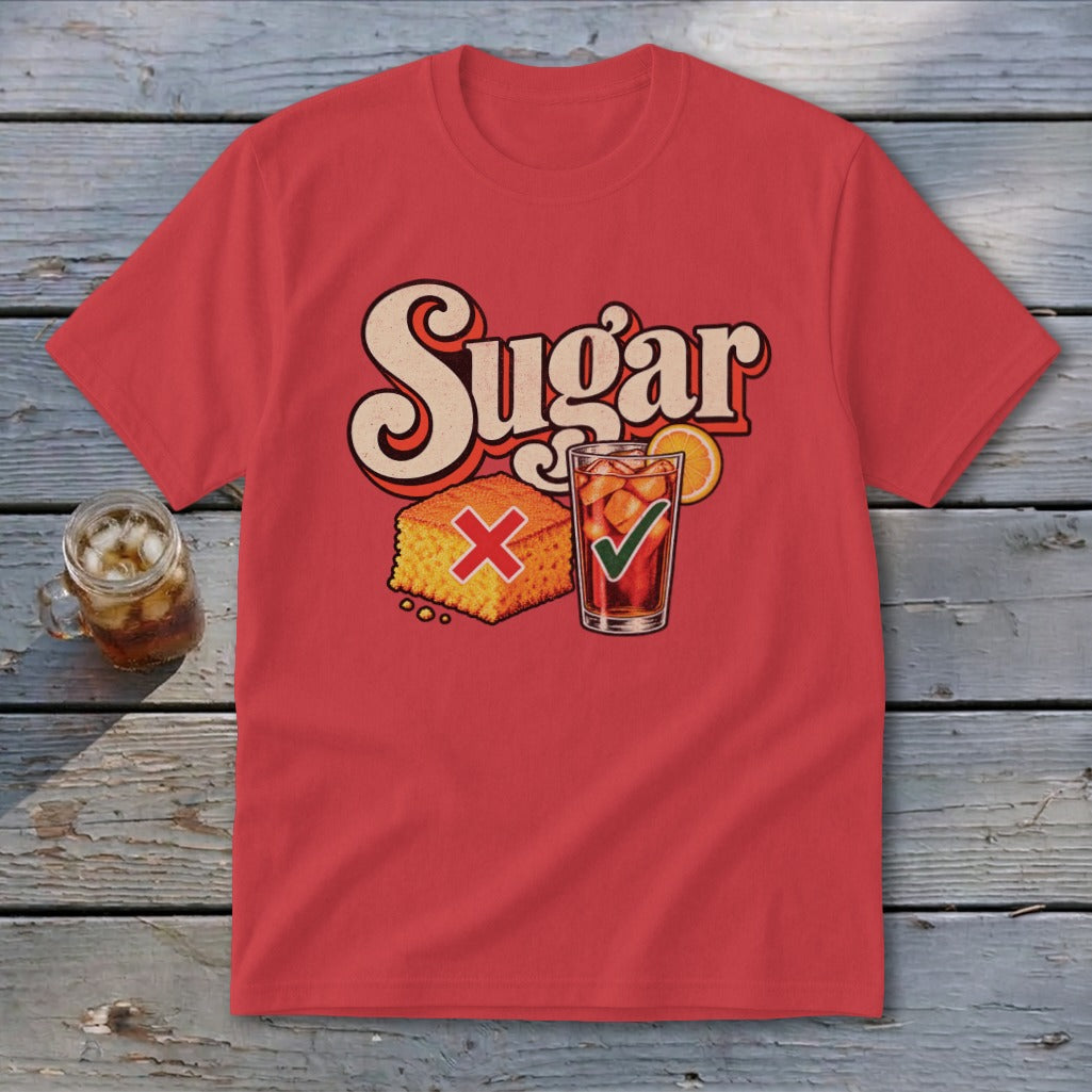 A red short-sleeve t-shirt with retro graphic text reading Sugar above a cornbread square marked with a red X and an iced tea marked with a green checkmark.