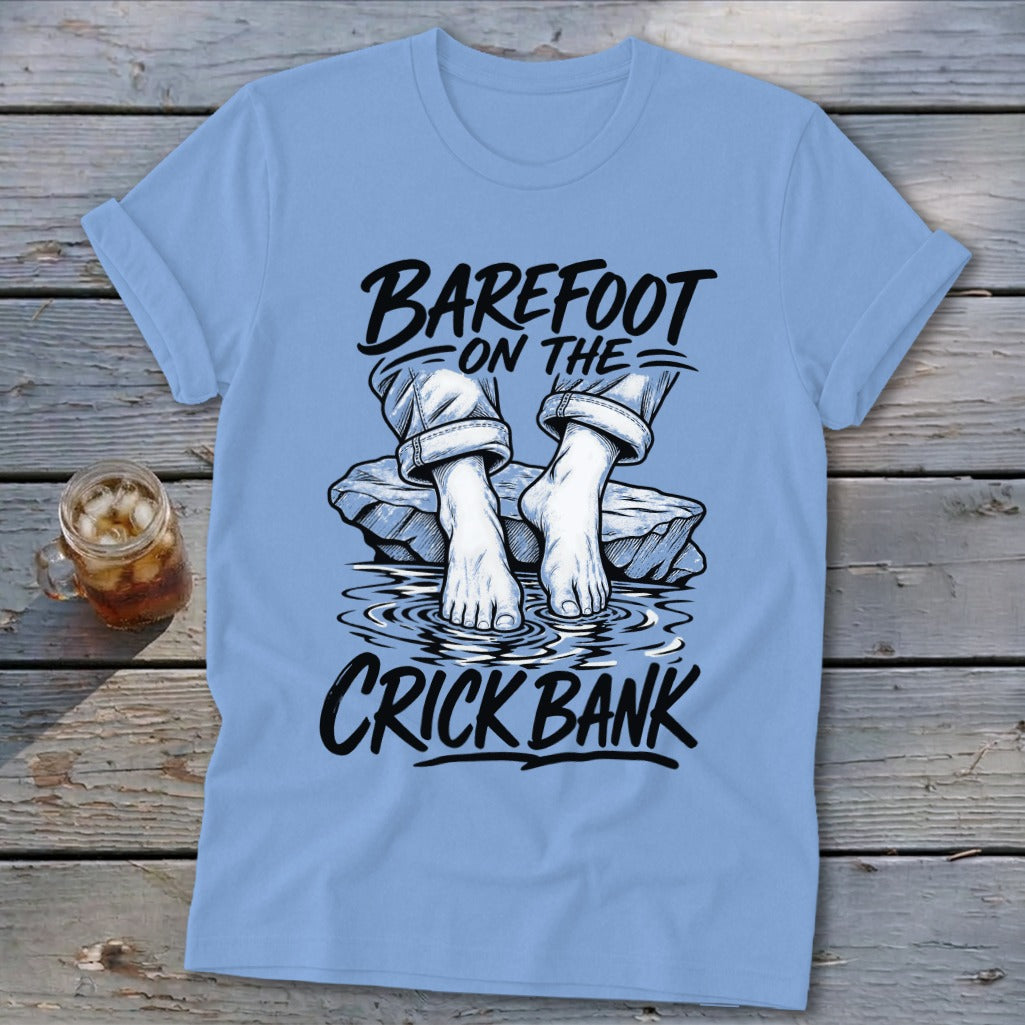 Light blue t-shirt with "Barefoot on the Crick Bank" graphic.