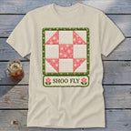 Cream t-shirt featuring a shoofly quilt block design with pink floral accents.