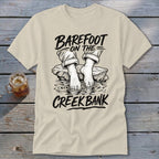 Cream t-shirt with "Barefoot on the Creek Bank" graphic of feet in water.