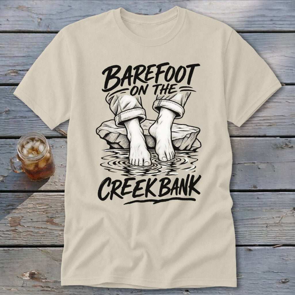 Cream t-shirt with "Barefoot on the Creek Bank" graphic of feet in water.