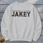 White sweatshirt with black text that reads "LOOKING A LITTLE JAKEY".