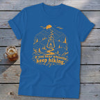 Blue t-shirt with yellow hiking graphic and text "If you hear whistlin', keep hiking."