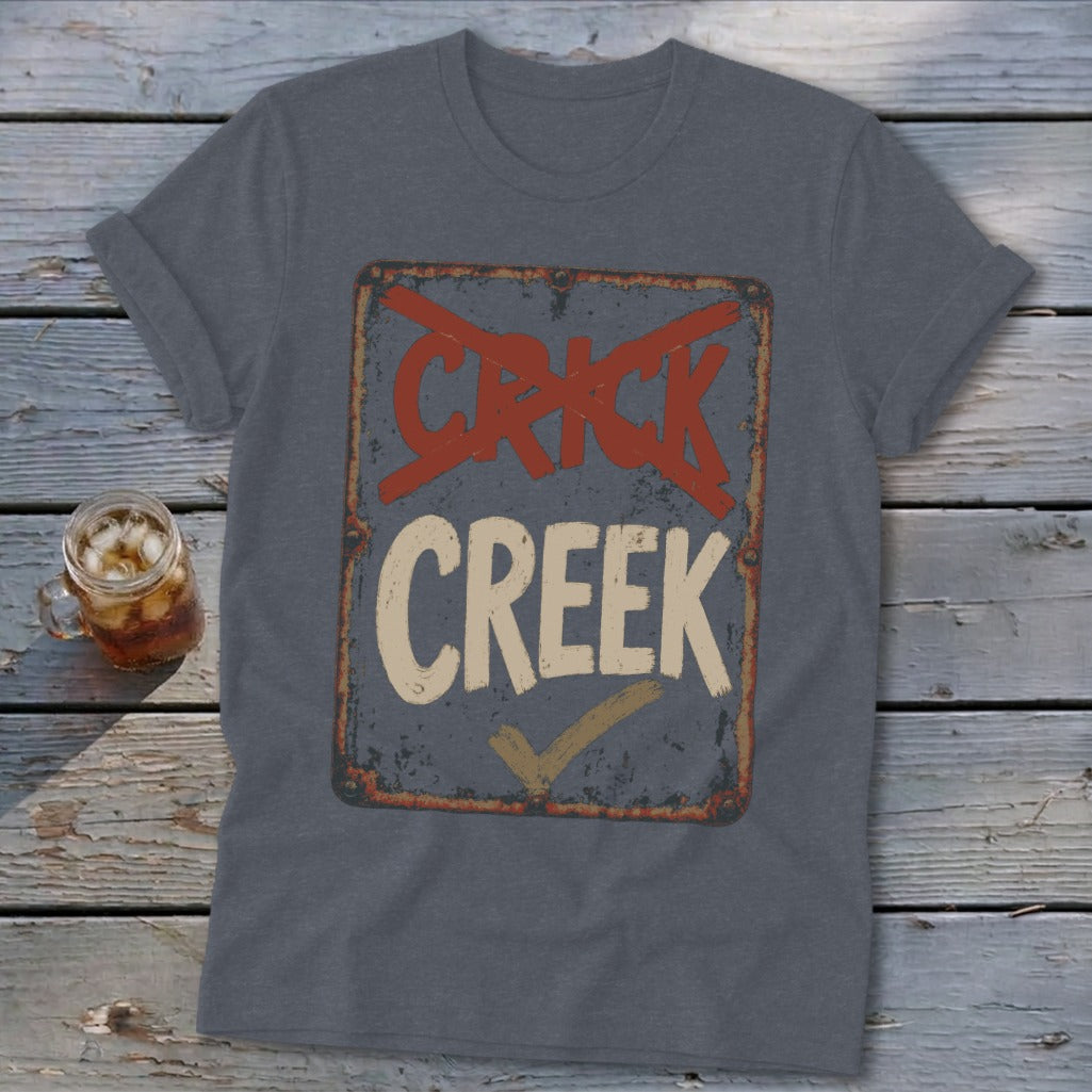 T-shirt with a distressed sign graphic reading "CRICK" crossed out and "CREEK" checked.