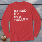Red long-sleeve shirt with white text "RAISED UP IN A HOLLER".