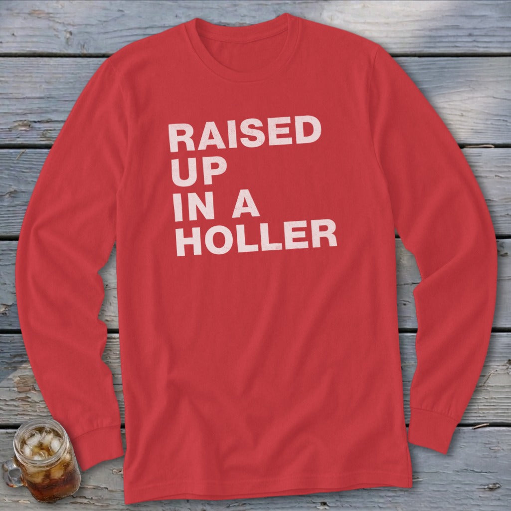 Red long-sleeve shirt with white text "RAISED UP IN A HOLLER".