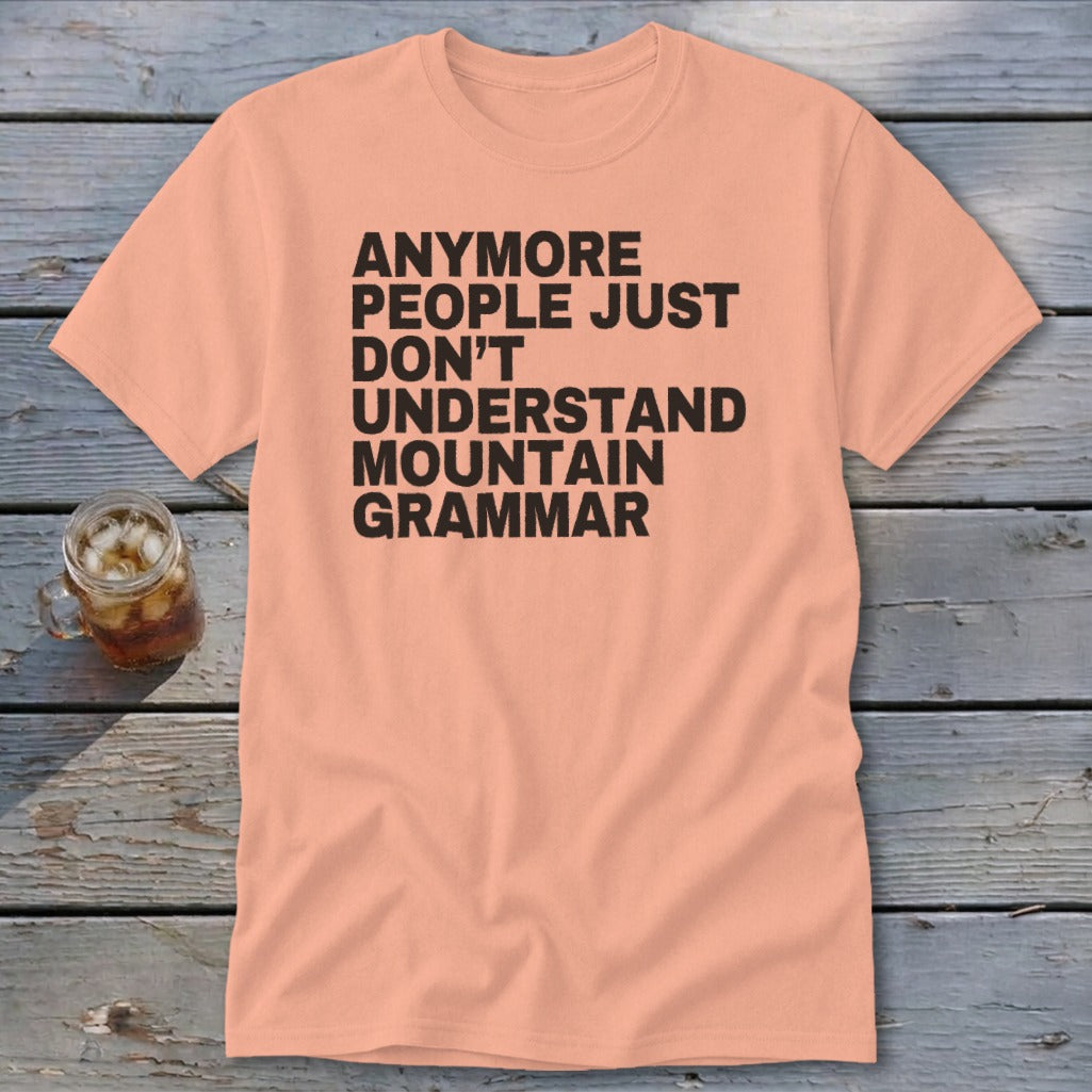 Peach t-shirt with black text that reads "Anymore people just don't understand mountain grammar."