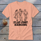 Peach t-shirt with black illustration of three people flat-foot dancing and text.
