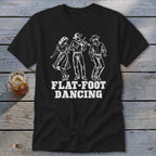 Black t-shirt with three line-art figures dancing and "FLAT-FOOT DANCING" text.