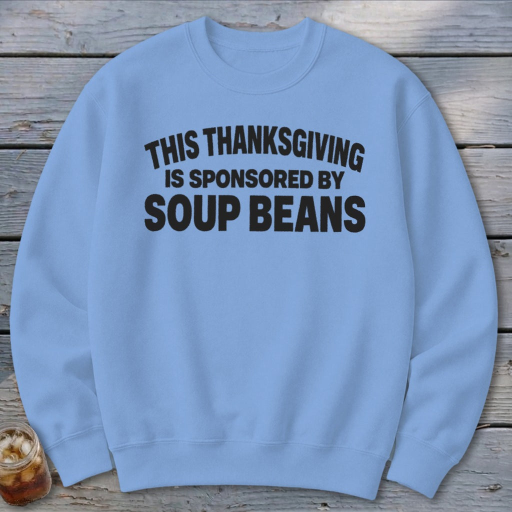 Light blue crewneck sweatshirt with black text reading This Thanksgiving is Sponsored by Soup Beans.